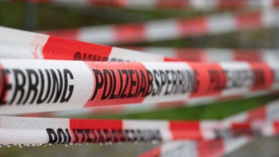 Absperrband der Polizei sperrt den Durchgang ab.
