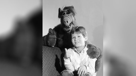 Alf und ein Junge halten beide die Daumen hoch.