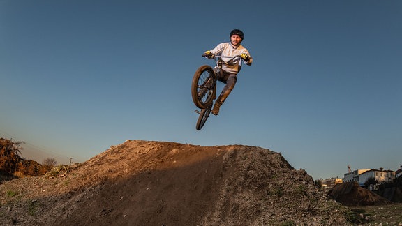 Ein Sportler springt auf einem BMX Rad