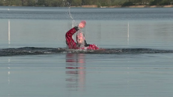 Bei einer Übung ruft eine Person im Wasser um Hilfe.