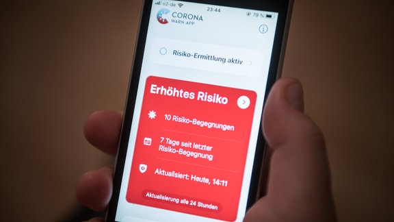 Ein Mobiltelefon mit geöffneter Corona Warn App und der Anzeige Erhöhtes Risiko