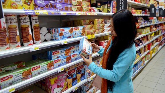 Frau an einem Regal im Supermarkt