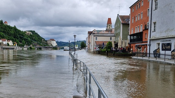 Eine Uferstraße ist vom Hochwasser überschwemmt.