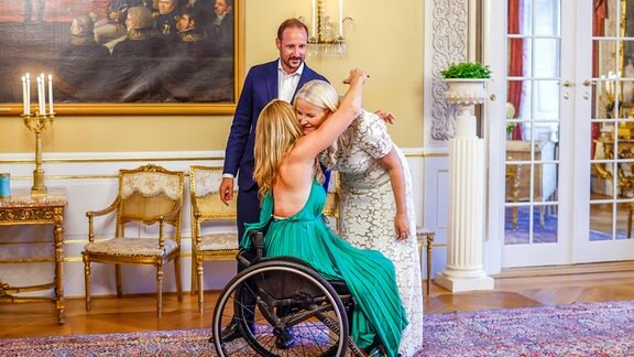 Birgit Skarstein, Parasportlerin aus Norwegen, umarmt Kronprinzessin Mette Marit von Norwegen, neben Kronprinz Haakon, als sie zu einer Geburtstagsparty im Palast eintrifft. 