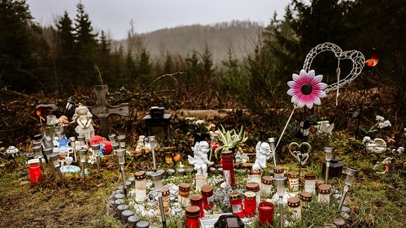 Kerzen, Blumen und Figuren liegen am Fundort an der Landesgrenze zwischen Rheinland-Pfalz und Nordrhein-Westfalen. 