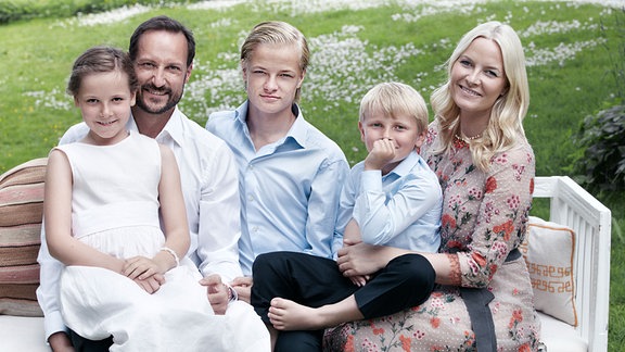Prinzessin Ingrid Alexandra von Norwegen (l-r), Kronprinz Haakon, Marius Høiby, Prinz Sverre Magnus und Kronprinzessin Mette-Marit sitzen fürs Familienfoto auf einer Gartenbank, am Nationalfeiertag, 2013