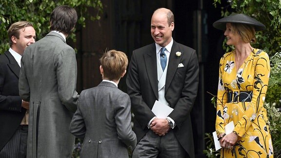 William, Prinz von Wales, spricht mit Hochzeitsgästen.
