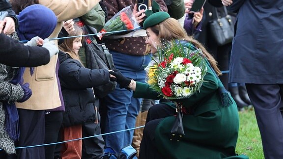 Eine Frau gibt einem Mädchen die Hand