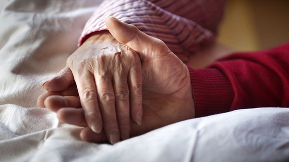 Hände halten in einem Hospiz.