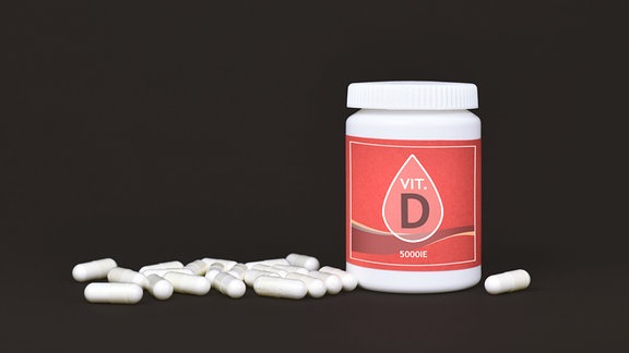Vitamin D vor schwarzem Grund.