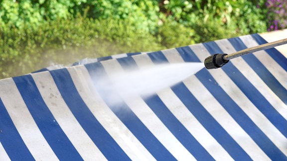 Markise wird mit Wasser gereinigt